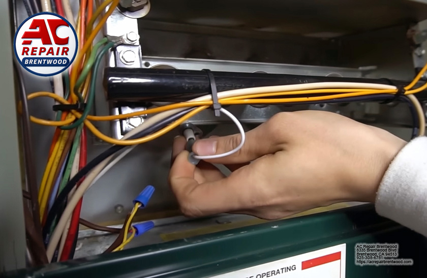 Technician repairing furnace components during emergency service call in Garin Ranch, Brentwood