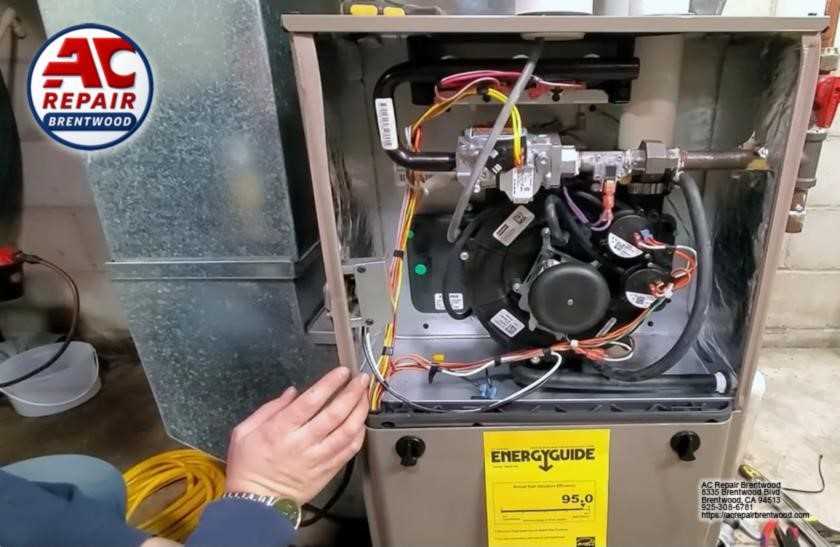 Technician diagnosing furnace components during repair service