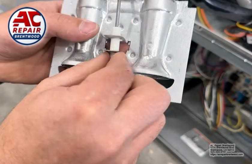 Technician servicing internal heat pump components during repair